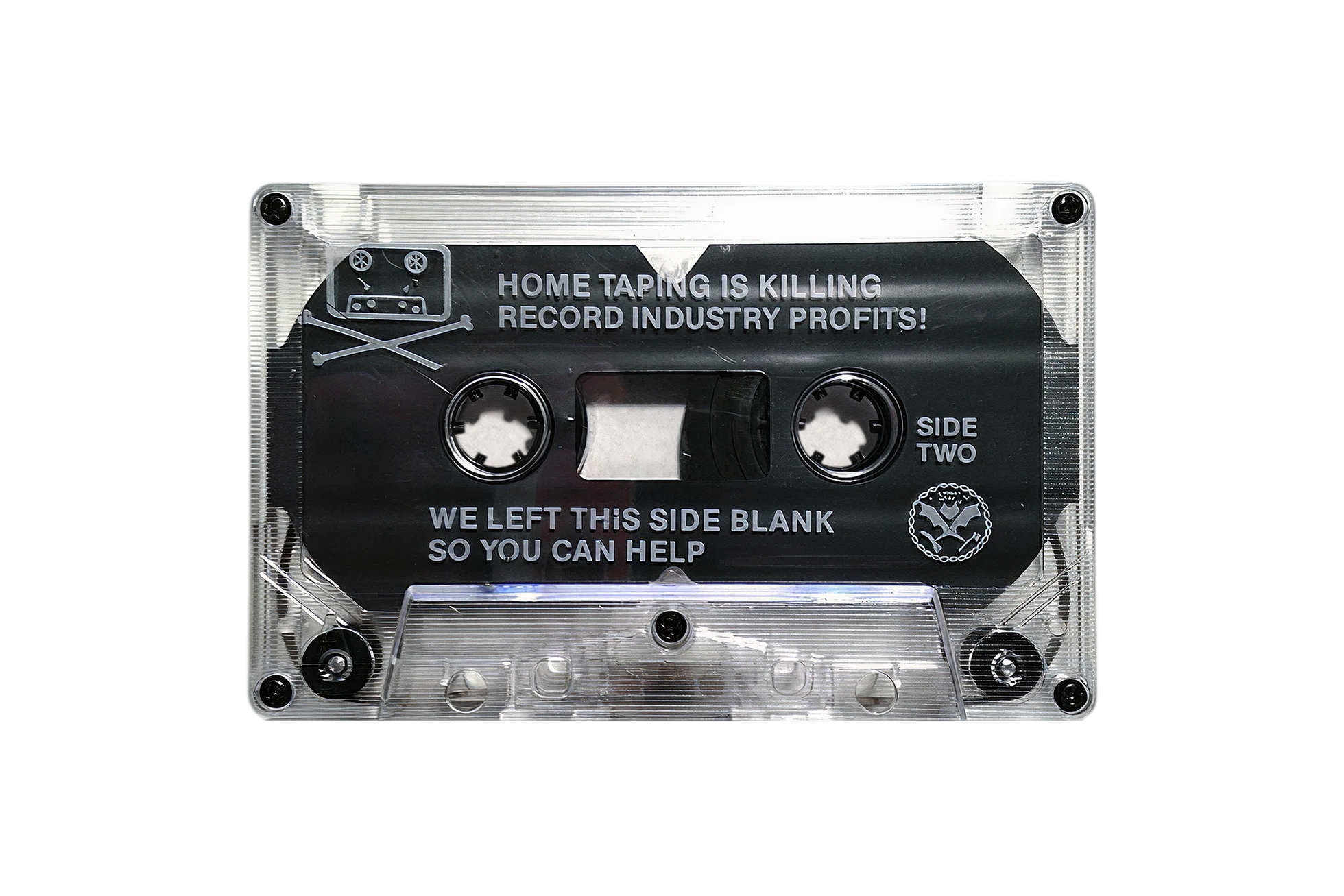 Side two of the Dead Kennedys' In God We Trust, Inc. cassette — a translucent shell with a black label reading 'HOME TAPING IS KILLING RECORD INDUSTRY PROFITS!' above the tape window, and 'WE LEFT THIS SIDE BLANK SO YOU CAN HELP' below, with the Dead Kennedys logo at the right.